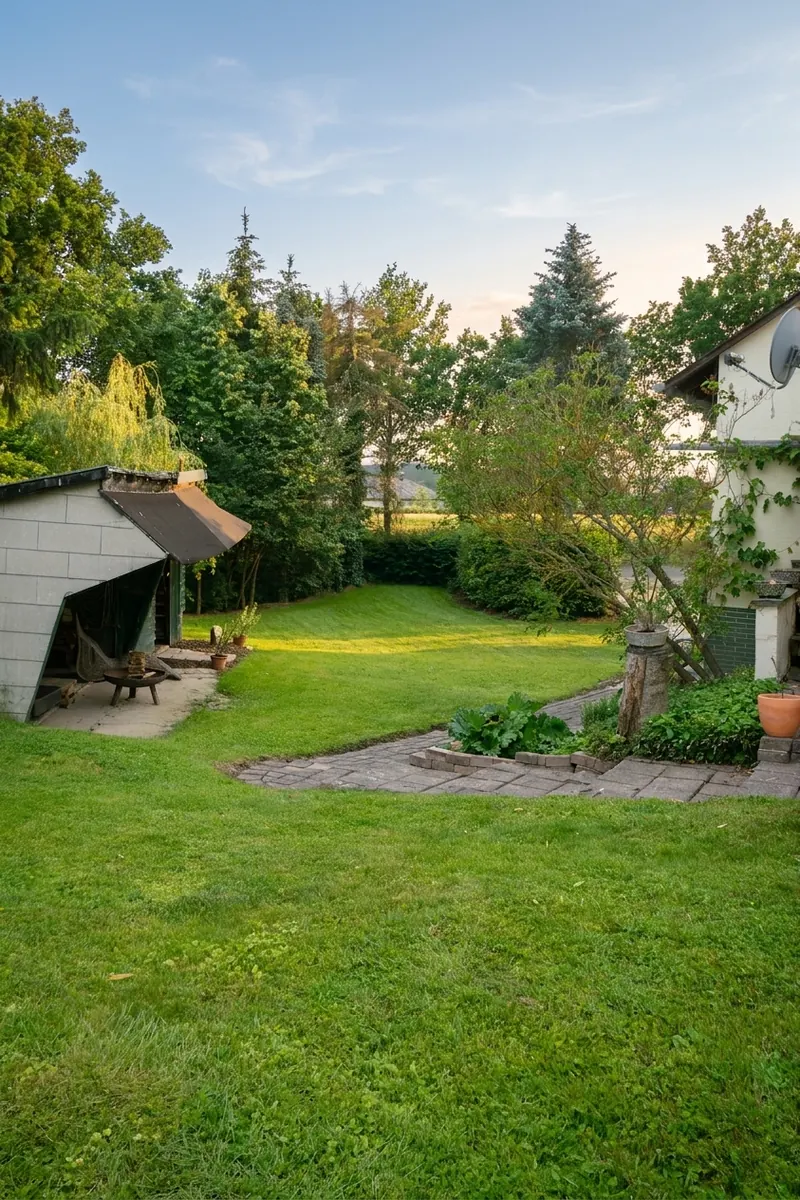 Weitläufiger Garten mit Schuppen im Abendlicht